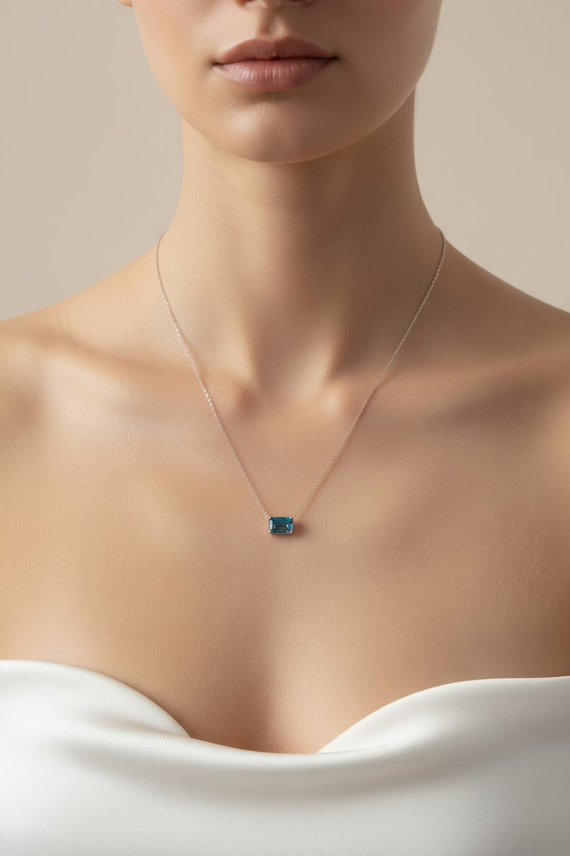 Model front-facing wearing blue topaz necklace